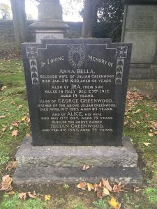 A large square black granite headstone with writing inscribed to the Greenwood Family in light grey lettering. There is a memorial inscription to Ira Greenwood killed in the war but not buried here.