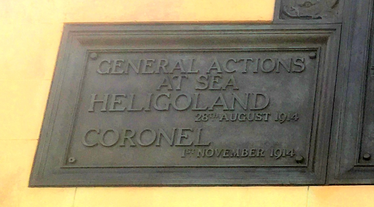 A bronze war memorial plaque which says 'General actions at sea, Heligoland 28th August 1914. Coronel 1st November 1914.'