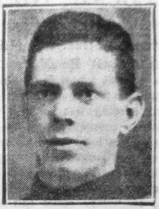 A newspaper quality image of a man's head and neck with him facing slightly to the left of the picture. He is clean shaven with short dark hair and appears to be wearing an Army jacket.