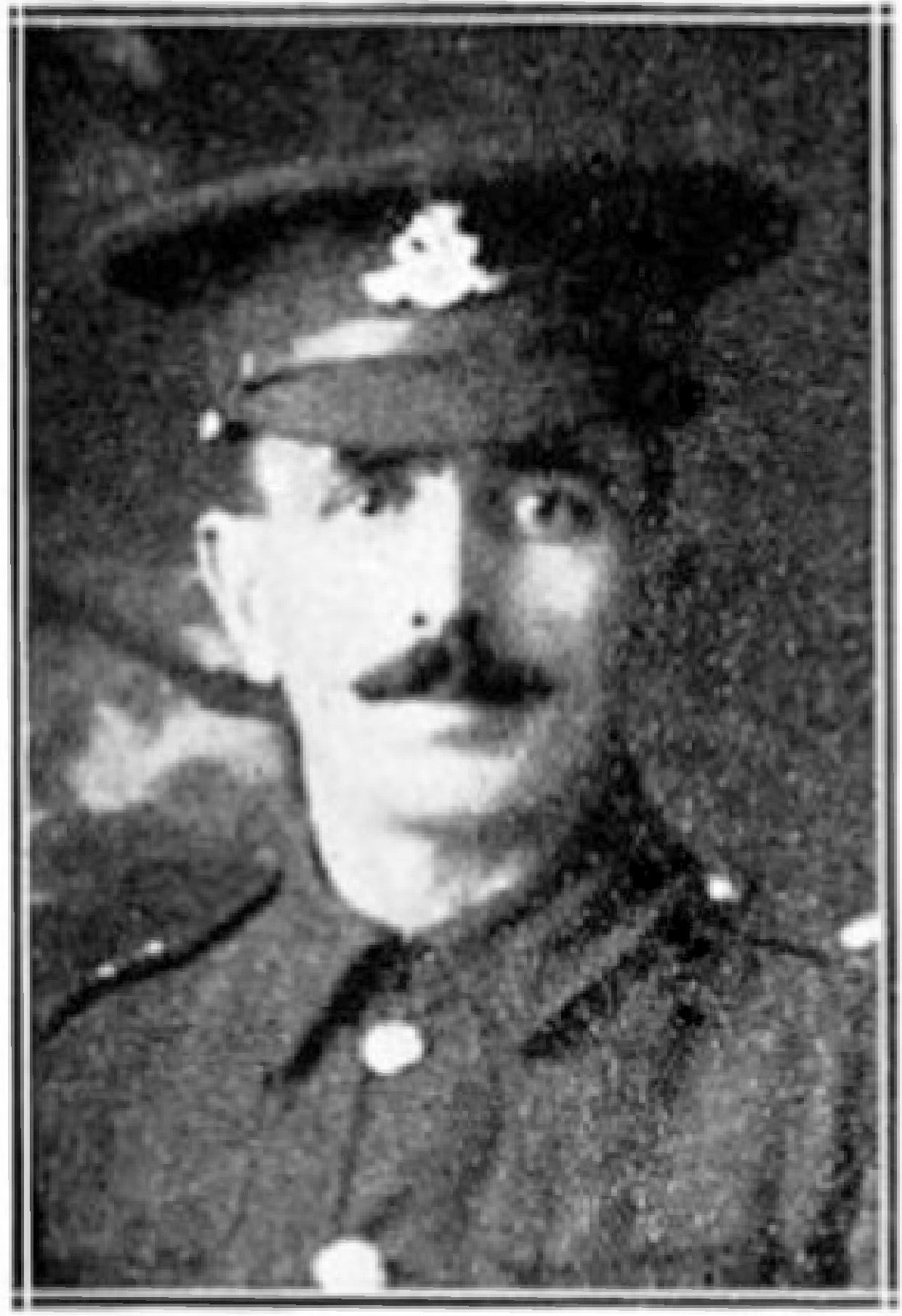 A WW1 British Army soldier wearing a peaked cap and jacket.