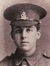 A soldier in uniform in a photographic studio.