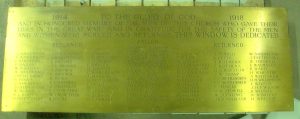 A rectangular brass plaque with 74 names in three columns on each side and one column of 16 names in the centre.