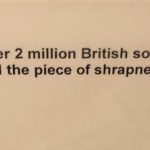 A museum display label describing the tiepin.