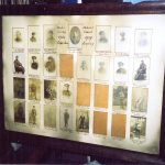 A framed and glazed war memorial with thirty photographs spaced apart in a special mount.
