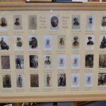 A framed and glazed war memorial with thirty photographs spaced apart with a special mount and calligraphic titles.