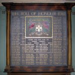 A framed painting which is a war memorial. There are 83 names on it, ten of which died in the war. There is a central square panel with the crest of the Oddfellows Society and all the names are painted in gold.