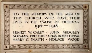 A white marble plaque mounted on a church wall. The wording says:
To The Memory of the Men of this Church who gave their lives in the Cause of Freedom. 1914 - 1918.
Ernest W. Caley - John MIdgley - Norman Preston - Chas Robertshaw - Harry C. Snaith - Horace Wood