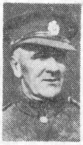 A poor quality newspaper photograph from 1940, of a soldier's head and shoulders. He is wearing a peaked cap and is facing the camera.