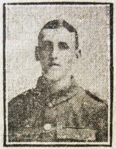A poor quality photograph from a 1916 newspaper. It is of a man's head and shoulders and he is facing the camera.