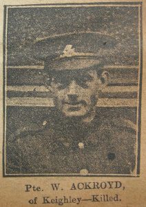 A poor quality newspaper photograph from 1917, of a soldier's head and shoulders. He is wearing a peaked cap with a West Riding Regiment badge and is facing the camera.