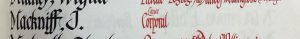 An entry in a roll of honour book. The name Mackniff, J is in black ink and the details: Lance Corporal, are in red ink.