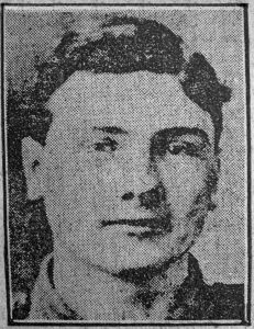 A low quality photograph from a 1916 newspaper. It is of a man's head and shoulders and he is facing the camera.