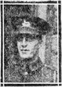 A newspaper image of a man's head and shoulders. He is wearing Army uniform and a peaked cap with a badge.