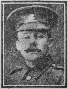 A newspaper image of a man's head and shoulders. He is wearing Army uniform and a peaked cap with a badge.