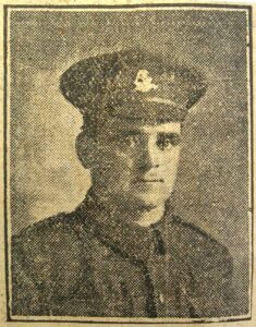 A newspaper photo of a British Army soldier in uniform. He is wearing the badge of the West Riding Regiment and is facing the camera.