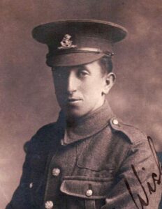 A studio portrait photo of a British Army soldier in uniform. He is wearing the badge of the West Riding Regiment.
